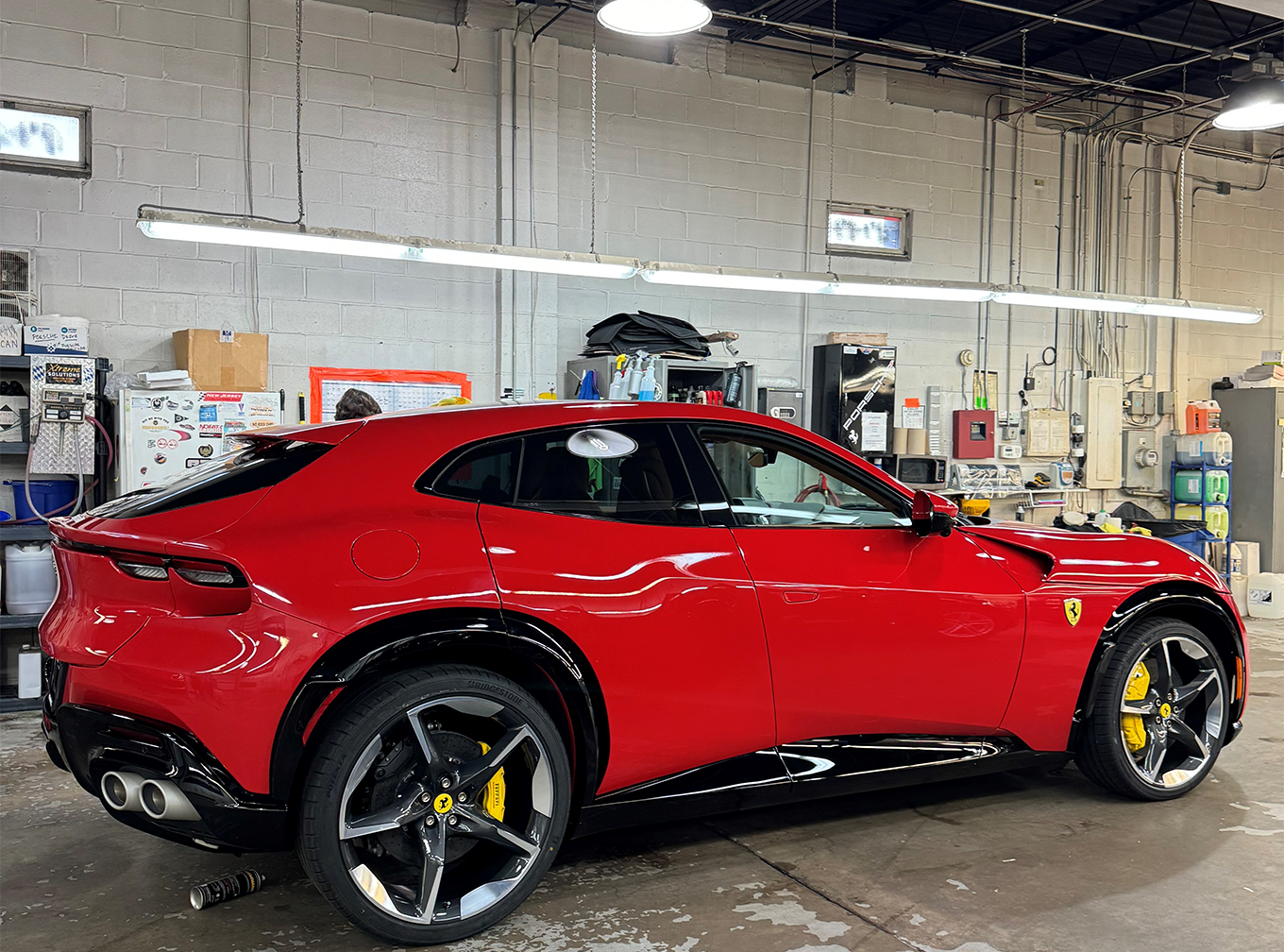 Red car serviced with mobile car wash